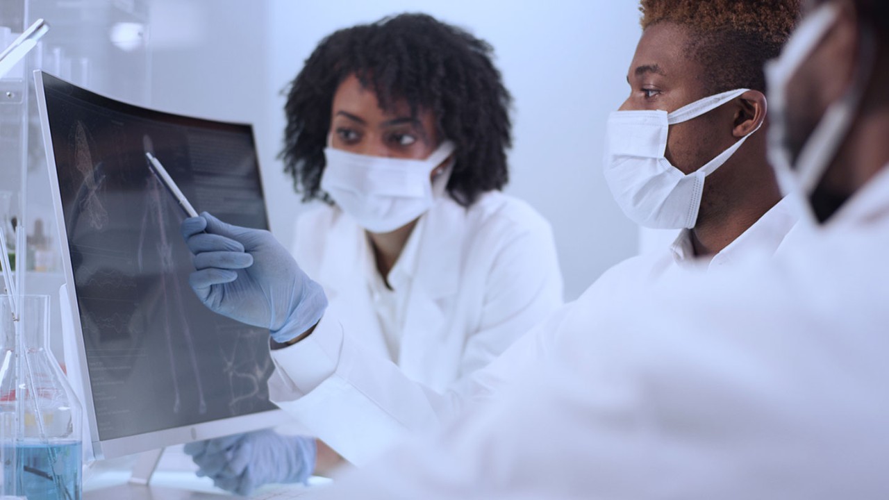 colleagues reviewing xray scan of human body