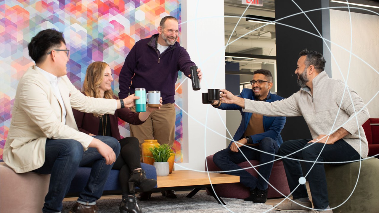 diverse group of employees cheering with coffee cups