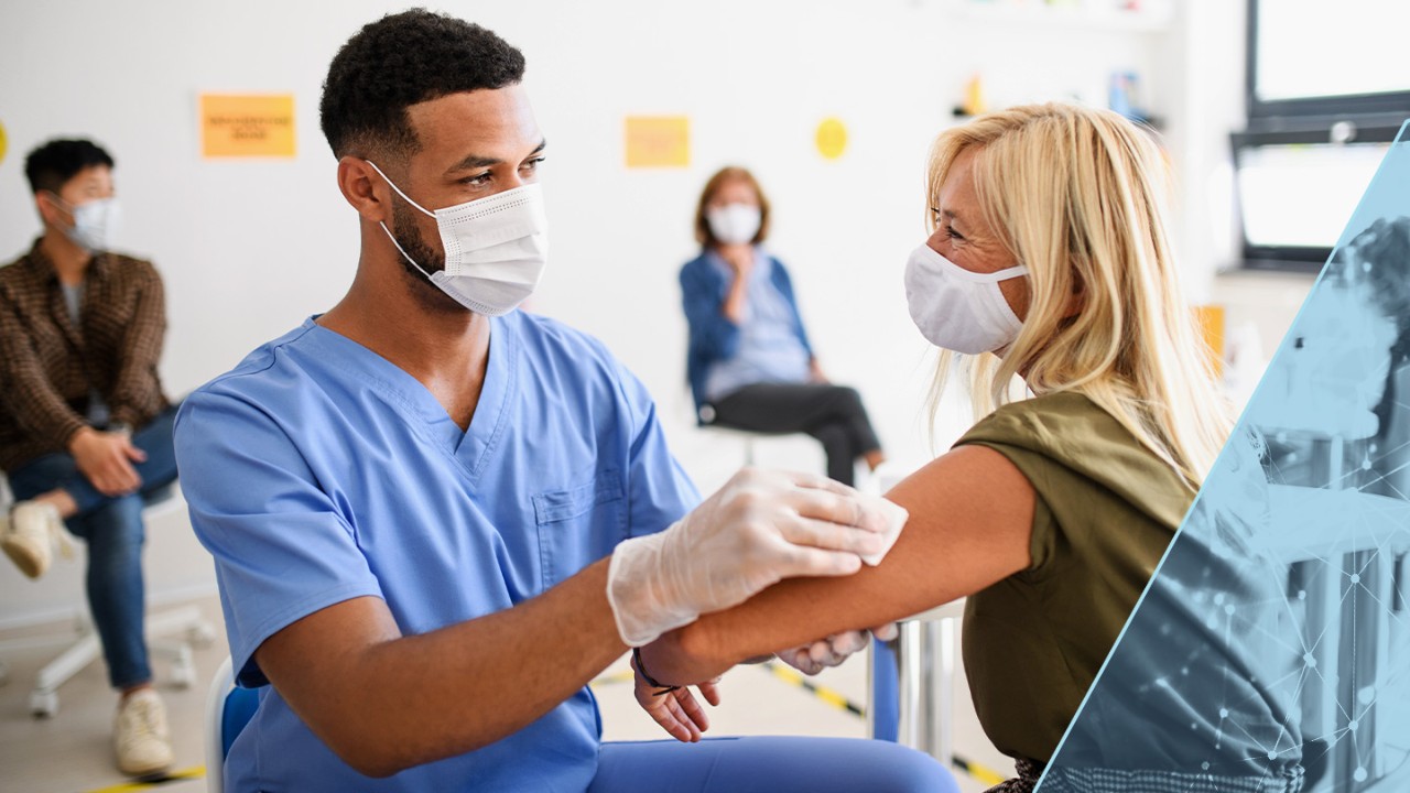 Male nurse disinfecting a female patient's arm to prepare for vaccination.