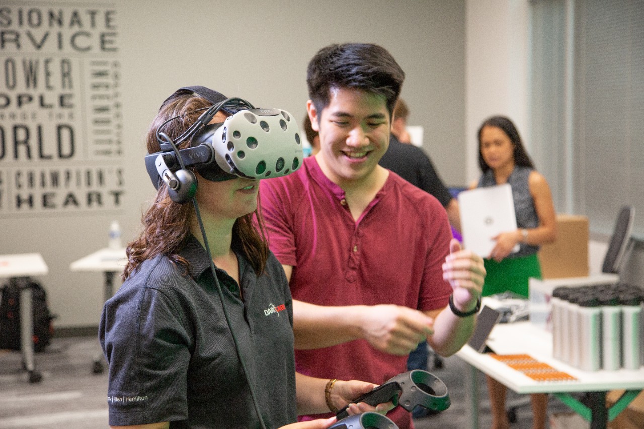 image of Booz employees testing out VR technology at the Annapolis Junction, MD, office