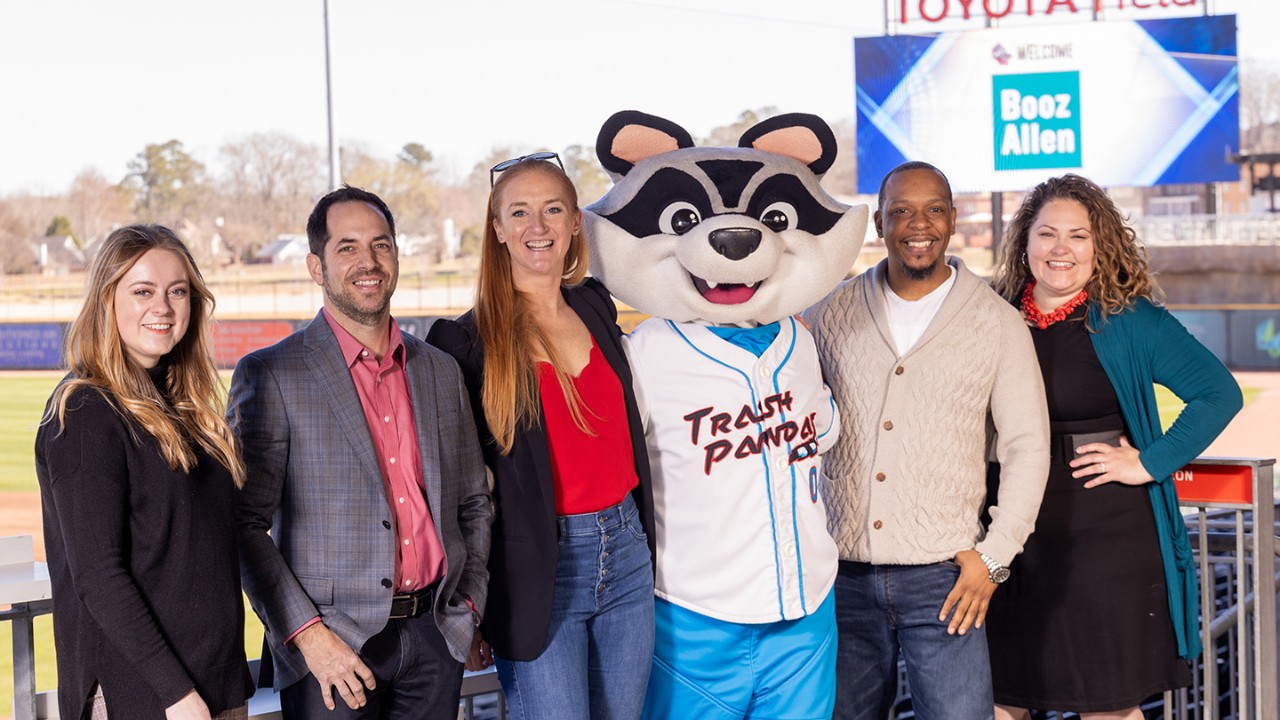 Booz Allen staff posing with Trash Pandas team